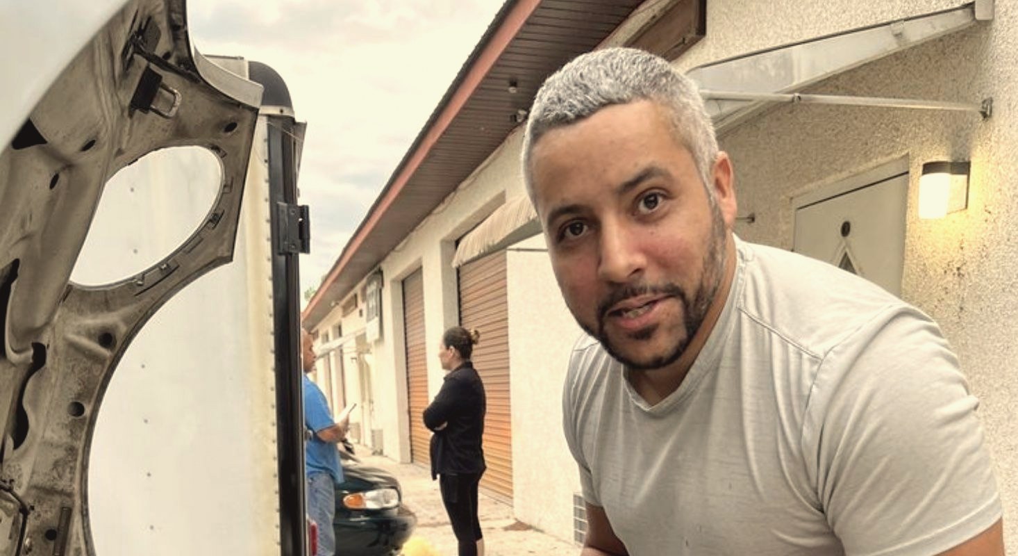 An AF Auto mechanic working under the hood